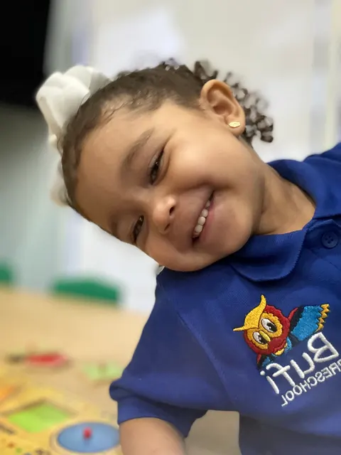 A girl smiling closely at the camera