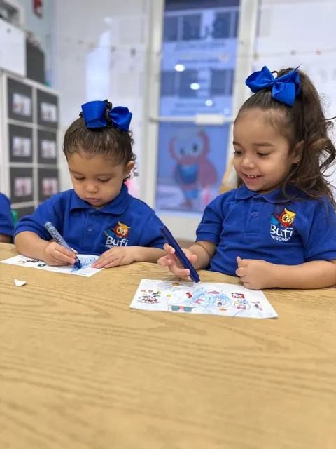 Two girls coloring together at the table